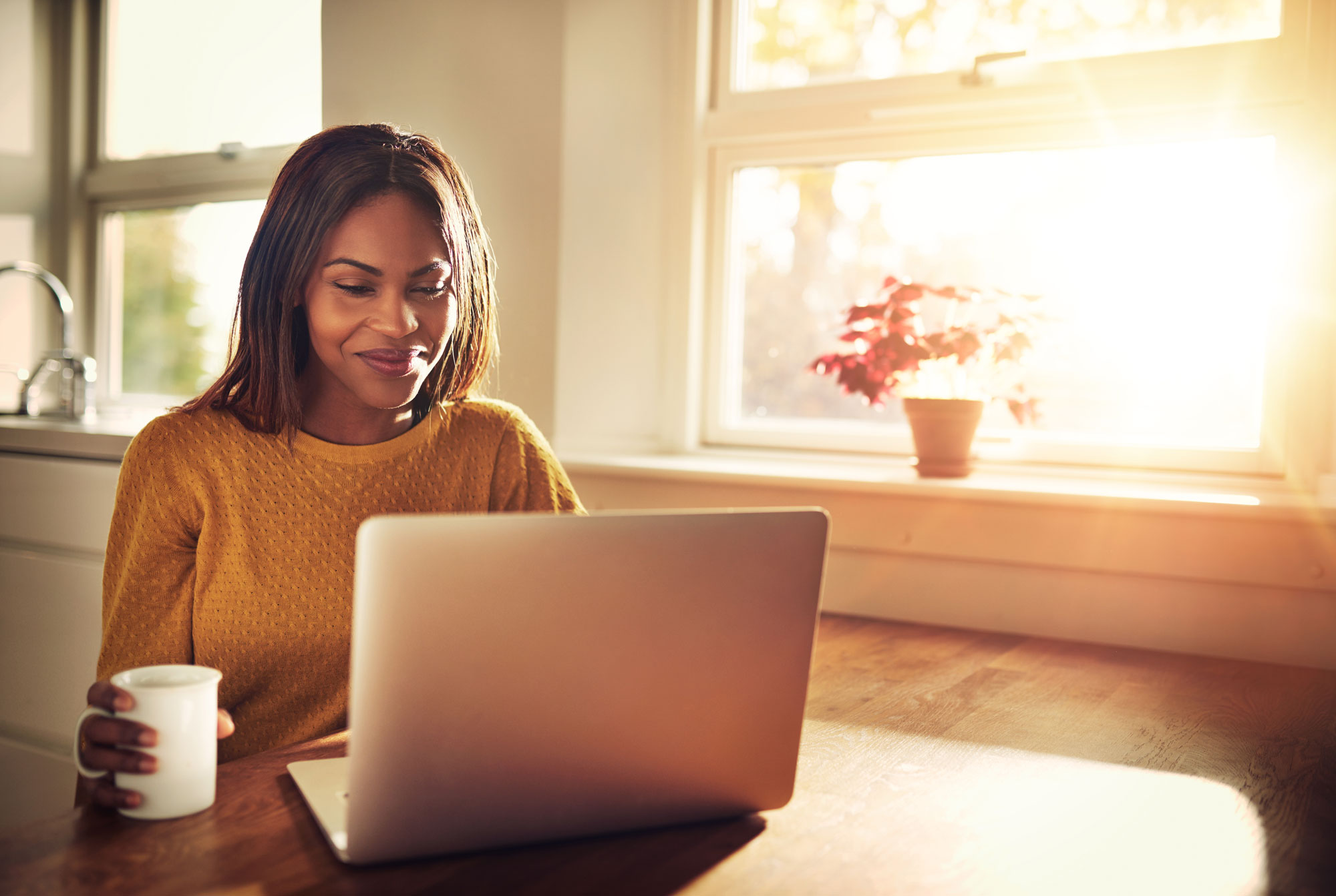 A woman smiling on a laptop